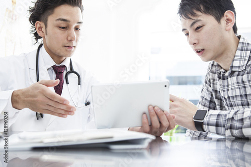 A young man is undergoing medical examination in internal medicine