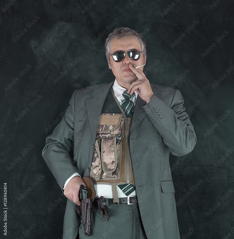 Fotka „CIA agent, a studio portrait of a security guard, bodyguard,  detective, mafia“ ze služby Stock | Adobe Stock