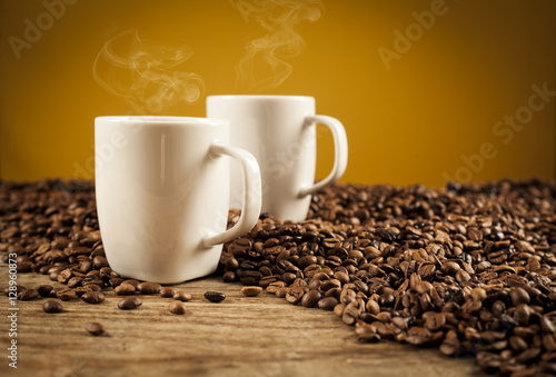 Porcelain cups of coffee on brown background