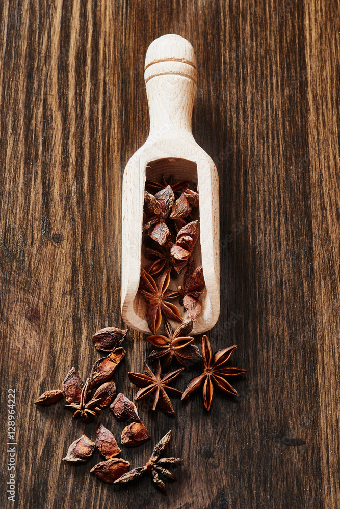 Star anise on spoon and wooden table Star anise on spoon and wooden table
