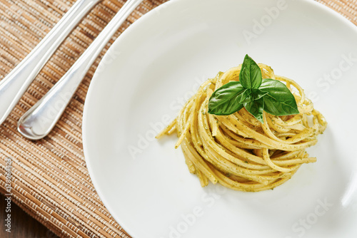 Pasta with pesto sauce in white dish