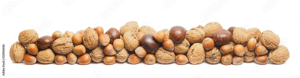 Walnuts, hazelnuts and chestnuts stacked on top - isolated on white backdrop Walnuts, hazelnuts and chestnuts stacked on top - isolated on white backdrop