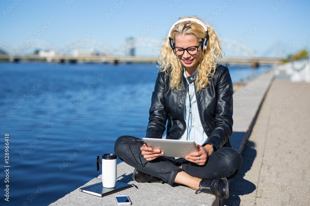 Woman with headphones using tablet