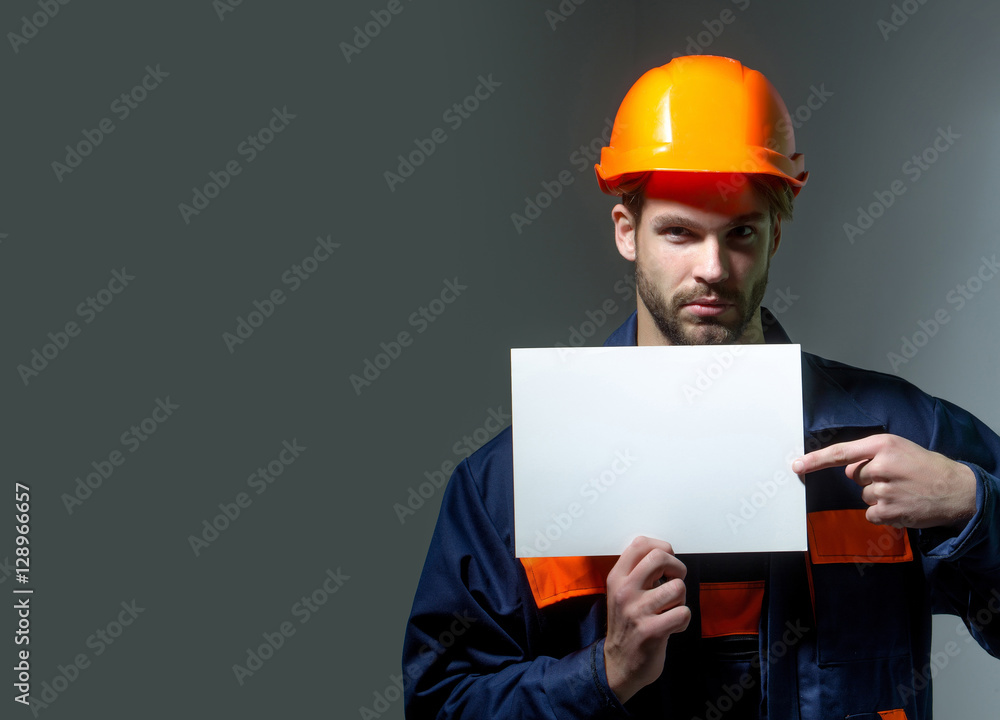 Serious man keeps blank paper