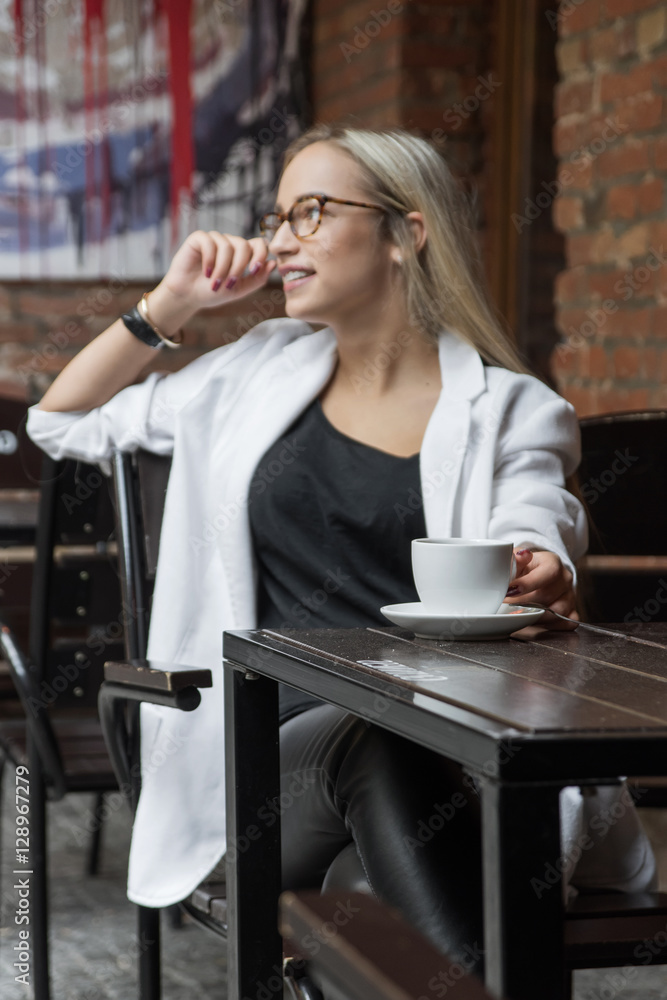 young business woman blonde in glasses in cafe young business woman blonde in glasses in cafe