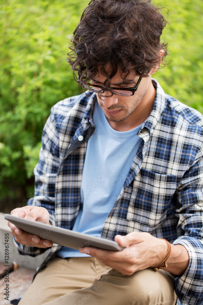 man in glasses with tablet pc computer outdoors man in glasses with tablet pc computer outdoors