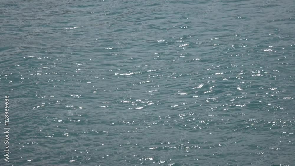 Side look at amazing sea waves. Ripple of green and blue water surface far from shore. Beautiful background for amazing intro in excellent 4k, 3840x2160 clip.
Side look at amazing sea waves. Ripple of green and blue water surface far from shore. Beautiful background for amazing intro in excellent 4k, 3840x2160 clip.