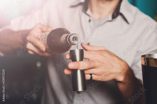 Barman's hands making shot cocktail