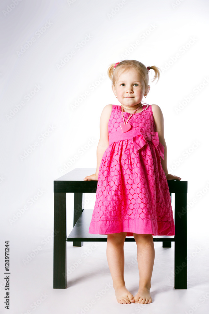cute little girl sitting on table cute little girl sitting on table