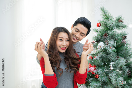 Christmas Asian Couple.Happy Smiling Family at home celebrating.