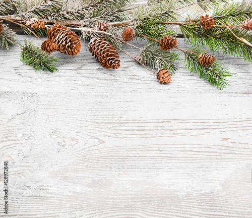 Christmas background with fir branches,pinecones and berries on