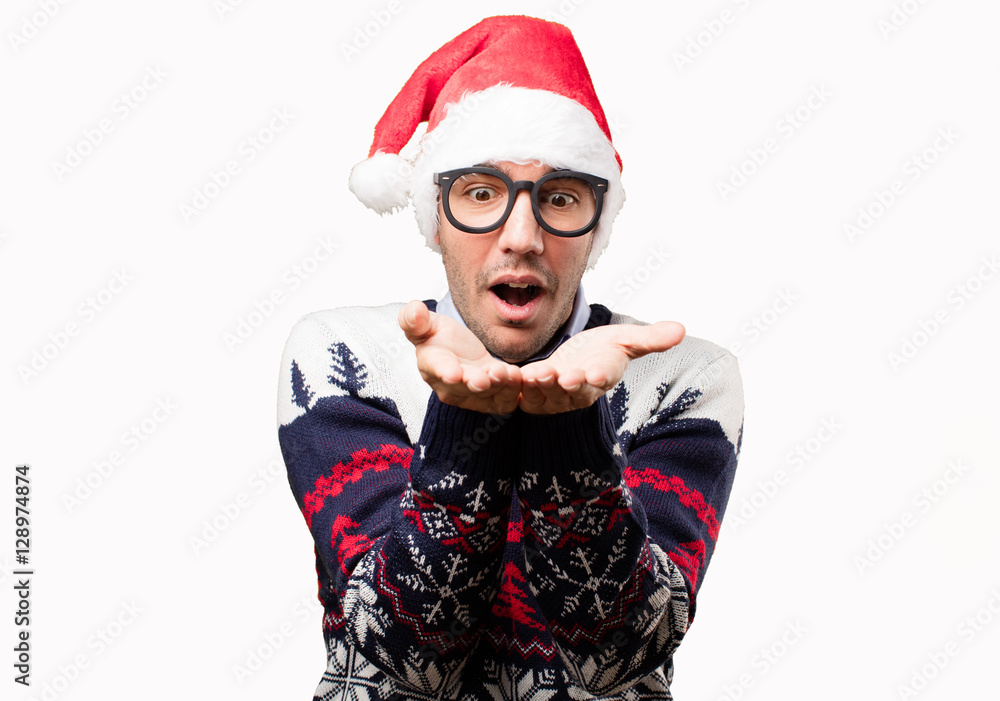 Happy young man with a gesture of show at Christmas Happy young man with a gesture of show at Christmas