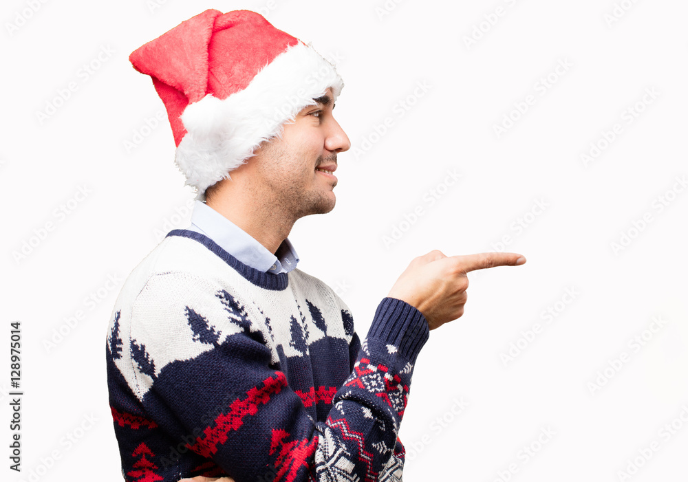 Surprised young man at Christmas pointing Surprised young man at Christmas pointing