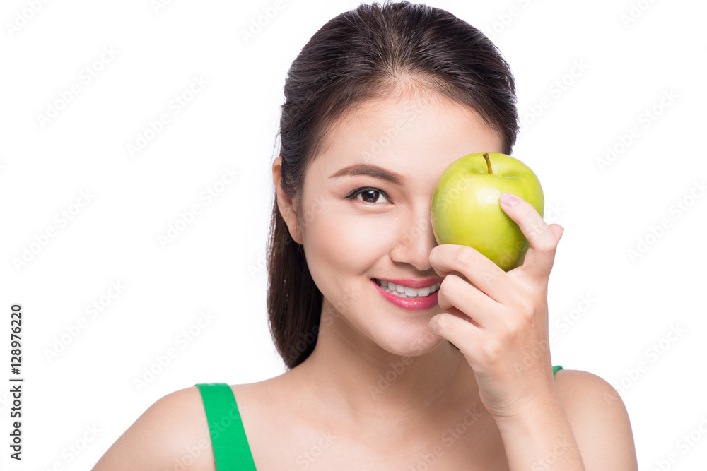Attractive smiling young asian woman eating green apple isolated Attractive smiling young asian woman eating green apple isolated