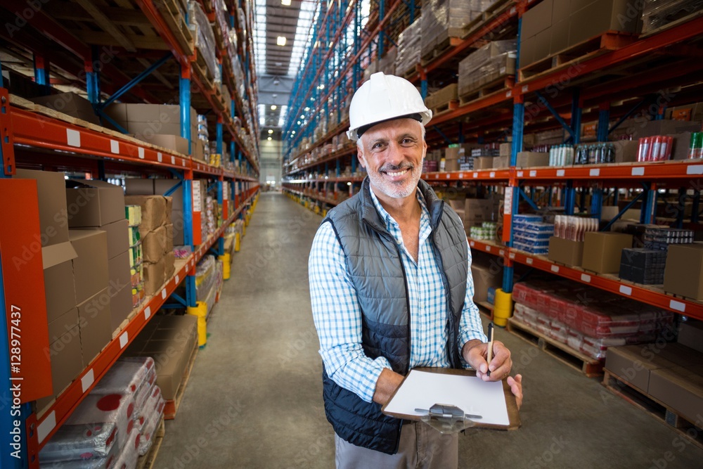 Warehouse worker holding clipboard Warehouse worker holding clipboard