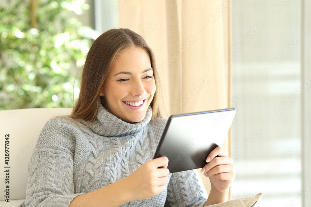 Girl using a tablet at home in winter Girl using a tablet at home in winter