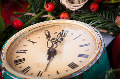 Green mistletoe and old clock 