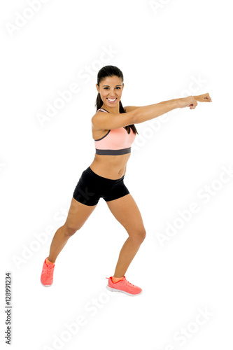 young beautiful latin woman in fitness clothes dancing zumba in aerobic workout happy and excited
