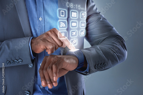 Smartwatch hologram on businessman's hands photo