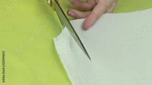 Tailor Scissors Cuts the Edge of Beige Fabric. Then Bends the Edge of the Fabric.