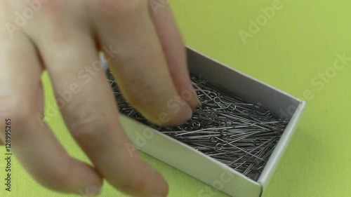 Girl Pulls Dressmaker Pins Out of the Box, and Then Puts Them Back.