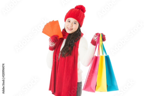 asian woman holding shopping bag and red envelope