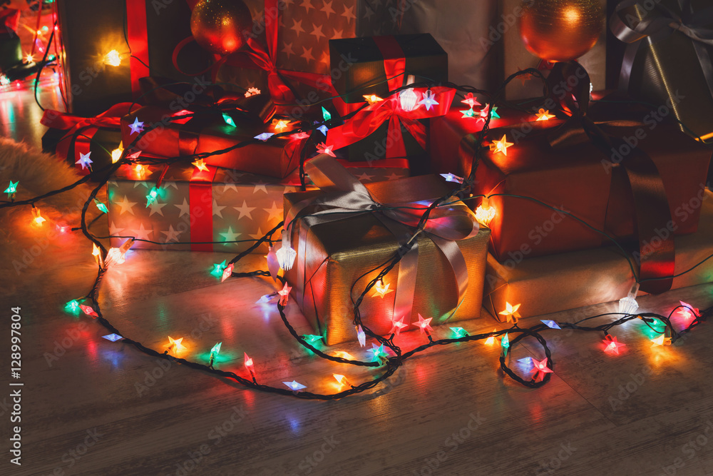 Christmas present and garland lights, holiday concept Christmas present and garland lights, holiday concept