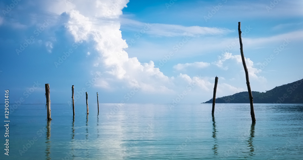 Cloudy sky over the sea at sunrise. Old wooden fishermen's jetty. Beautiful minimalistic serene scene.

