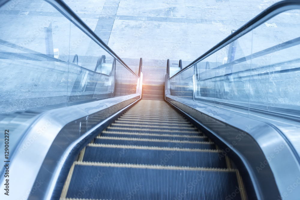 ascending escalator in a public transport area ascending escalator in a public transport area