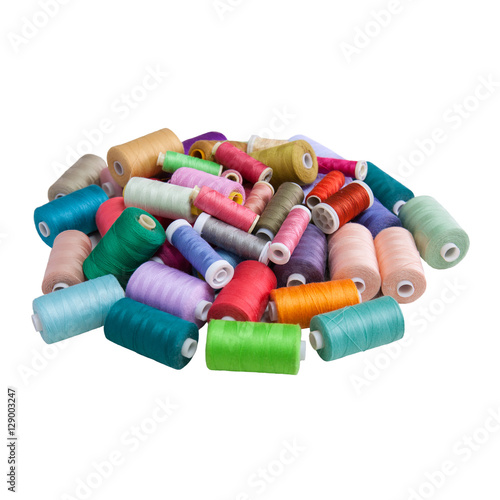 Snapshot of the pile of colorful spools of thread isolated on white background. Sewing concept.