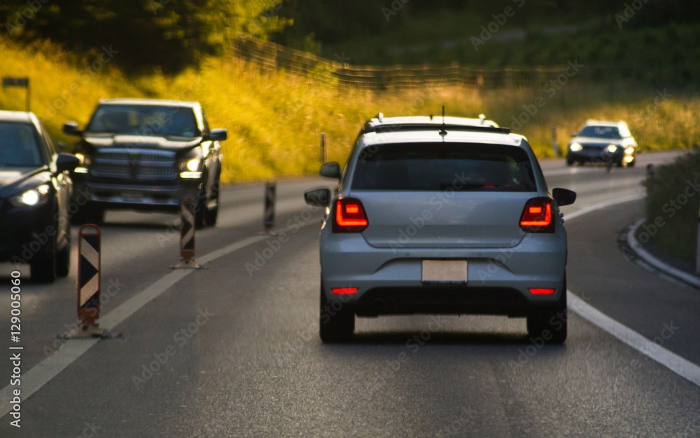 Fototapeta premium Cars on busy road driving in evening