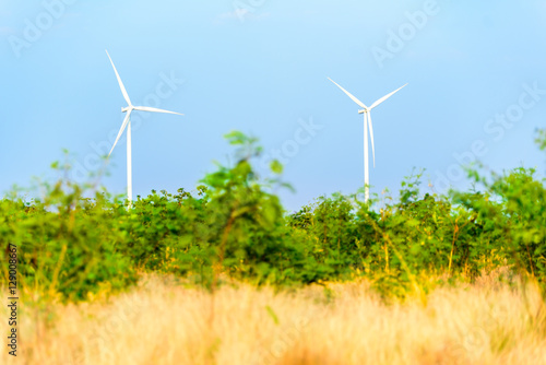 Two wind turbines make green in the field. © fasndee