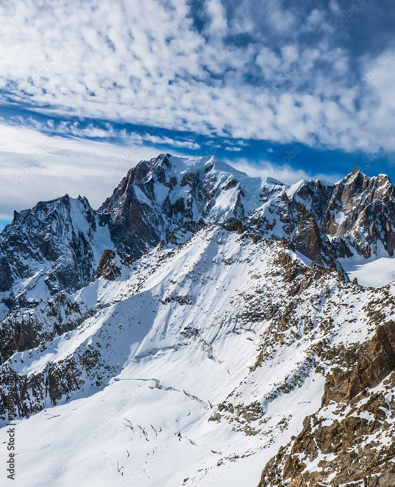 Snowy mountain peaks in North Italy and cloudscape