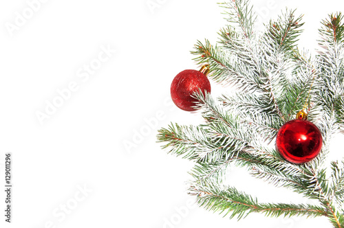 Fir branch decorated Christmas ornaments on a white background.