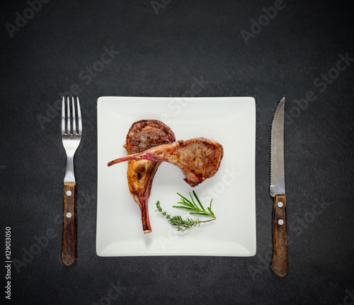 Obraz na plátně Lamb Steak on White Plate wit Fork and Knife