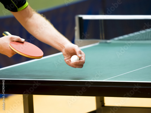 table tennis player serving, closeup - small depth of field, focus at the blade and ball!