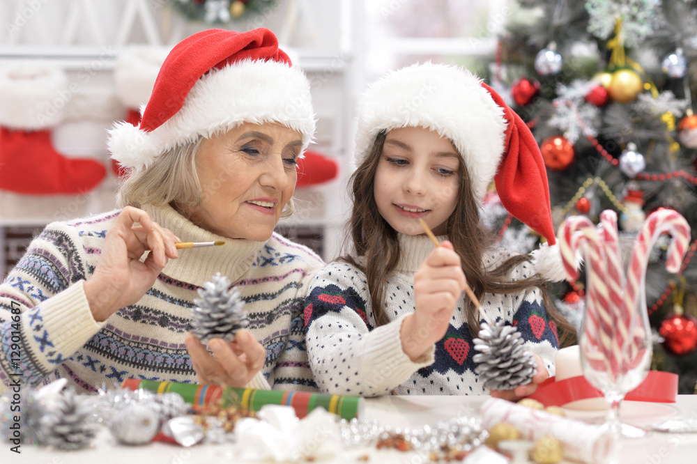 Grandmother with child preparing for Christmas Grandmother with child preparing for Christmas