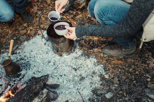 A group of people drinking tea, coffee and mulled wine in the ou photo