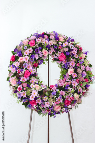 Colorful flower arrangement wreath for funerals isolated on white