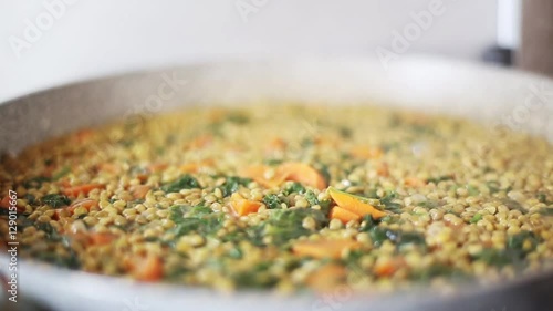 show cooking, lentils with spinach and red carrots prepared at home, italian recipe, healthy proteins food concept
