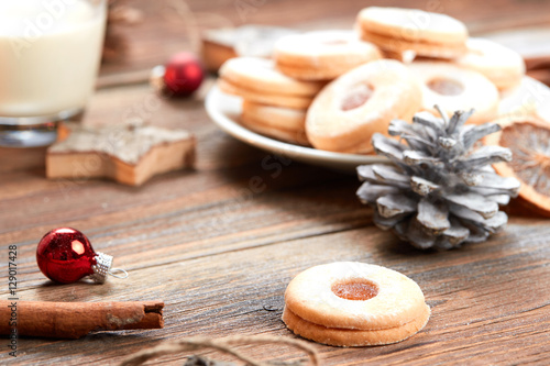 Pile of cookies on white plate on a wooden table