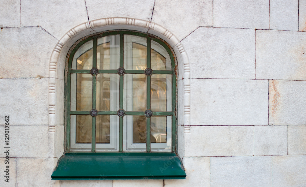 Historic green window on the yellow wall Historic green window on the yellow wall