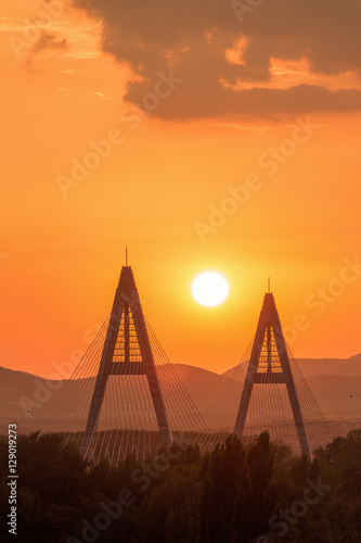 Sunset on a modern Megyiery bridge in Budapest, Hungary over Dan