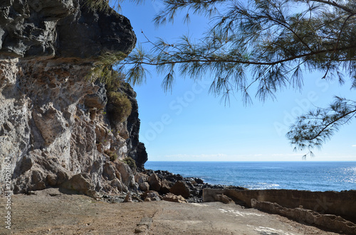 Cliffs at blue sky and clear blue water