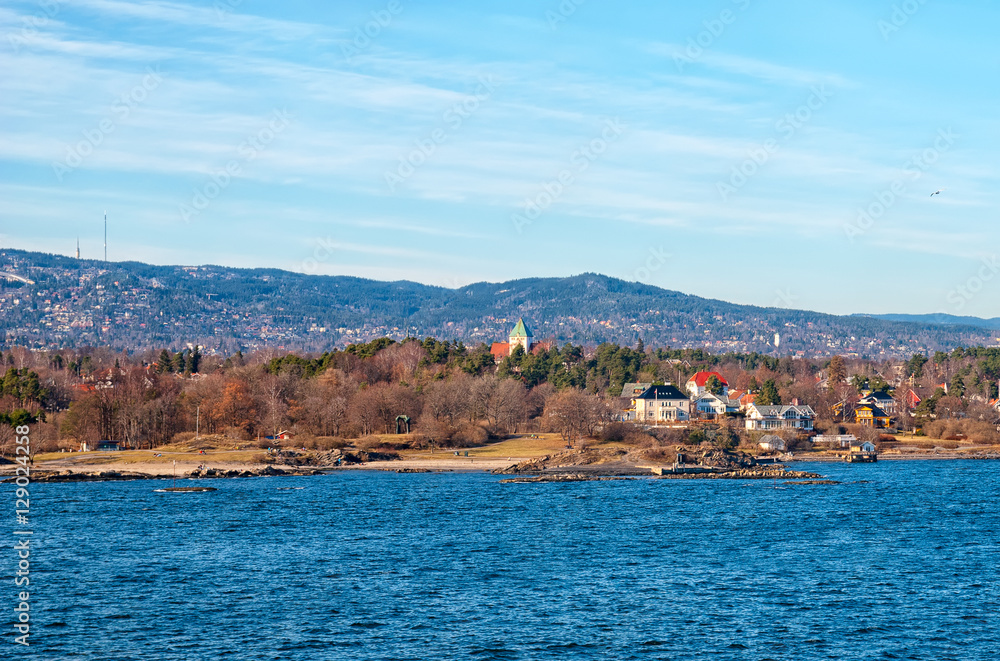 Fototapeta premium Oslo. Norway. Buildings on Peninsula Bygdoy. View from ferry boat
