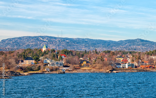 Photography Oslo. Norway. Buildings on Peninsula Bygdoy. View from ferry boat