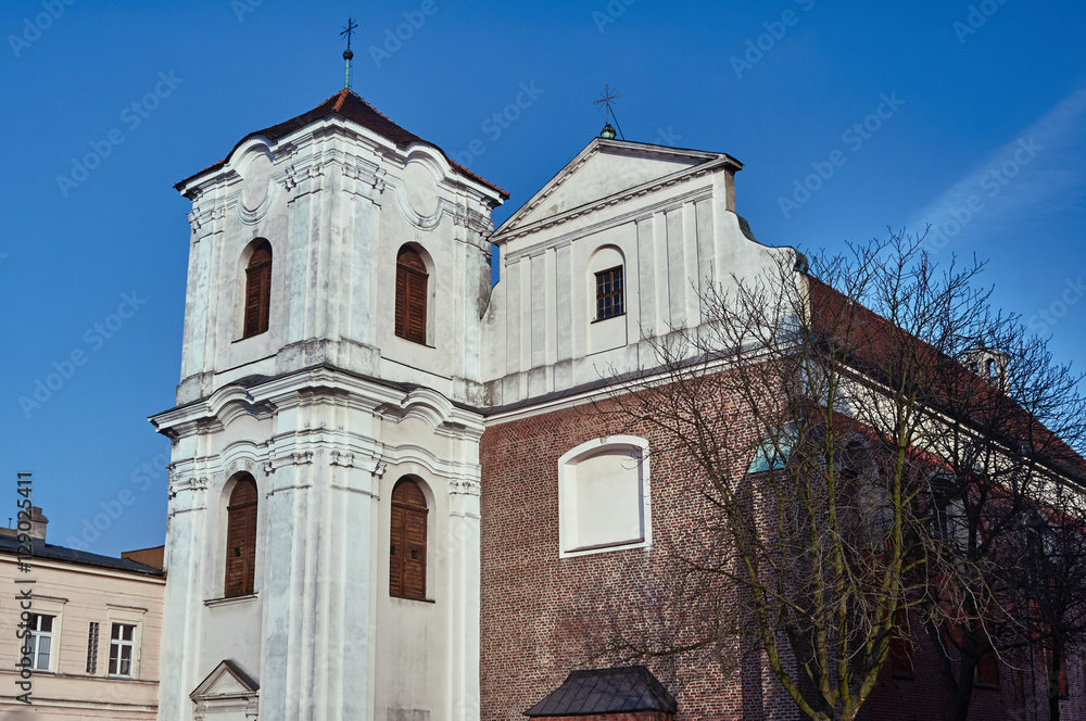 Fototapeta premium The facade of the Catholic church with a belfry in Poznan.