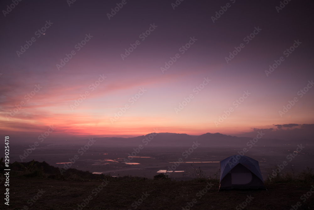 mountain dawn with tent, pink and violet colors of sky and cloud