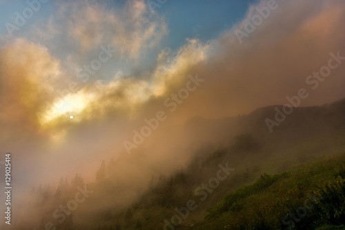 Foggy sunrise on Ceahlau mountain. Moldova. Romania
