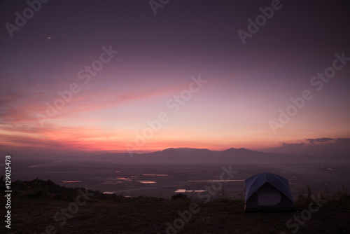 mountain dawn with tent, pink and violet colors of sky and cloud